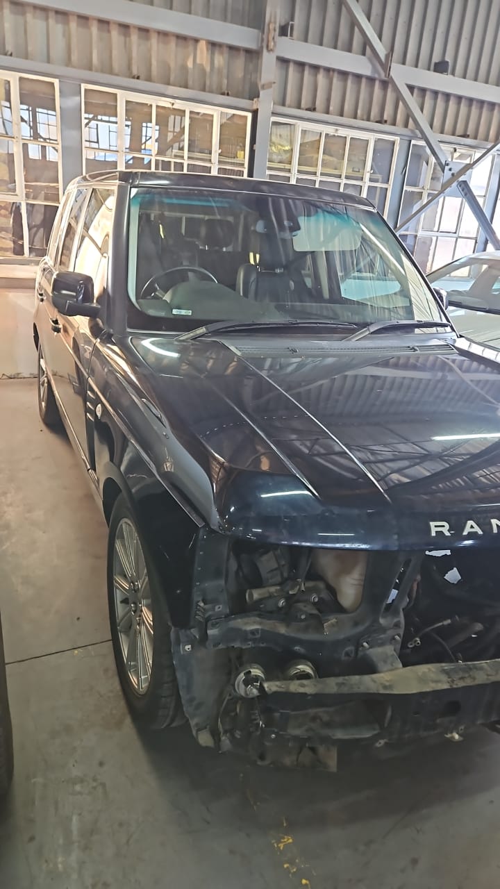 Black Range Rover in the Recon Engines workshop with bumper, headlights and front end removed.